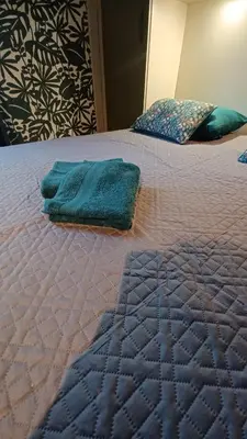 a bed with two towels sitting on top of it at Le petit chalet d' Anto-Francè in Levie