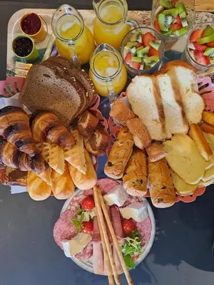a tray of food with bread and pastries and drinks at Le petit chalet d' Anto-Francè in Levie