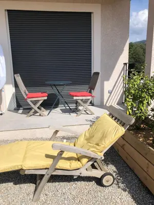 two chairs and a chaise lounge on a patio at Villa Jade in Sartène