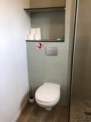 a bathroom with a toilet in a room at Villa Jade in Sartène