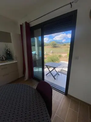 a room with a sliding glass door to a patio at Villa Jade in Sartène