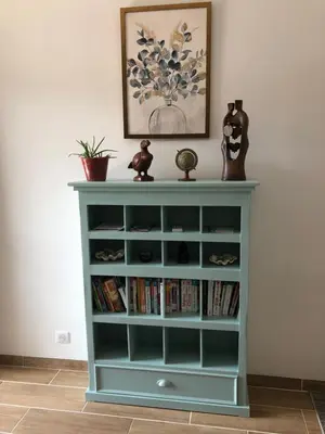 a blue book shelf with books on it at Villa Jade in Sartène