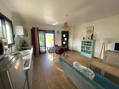 a kitchen and living room with a couch and a table at Villa Jade in Sartène