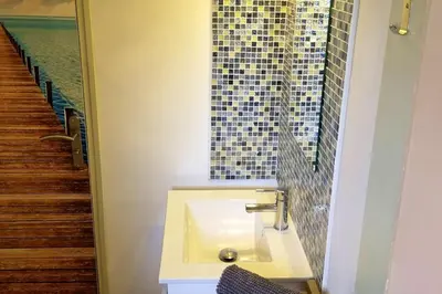 a bathroom with a sink and a mosaic window at Villa charmante à Porto-Vecchio avec piscine in Porto-Vecchio