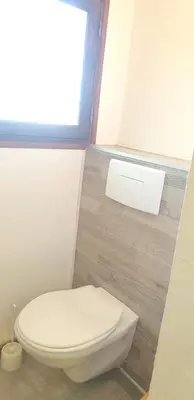 a white toilet in a bathroom with a window at Villa charmante à Porto-Vecchio avec piscine in Porto-Vecchio