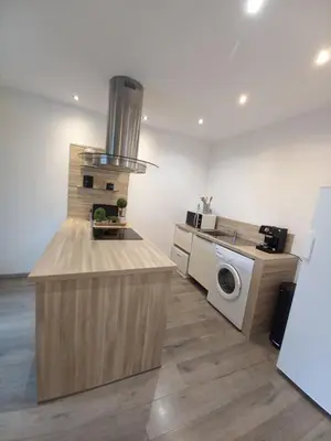 a kitchen with a stove and a washing machine at afa butrone sarrola in Afa