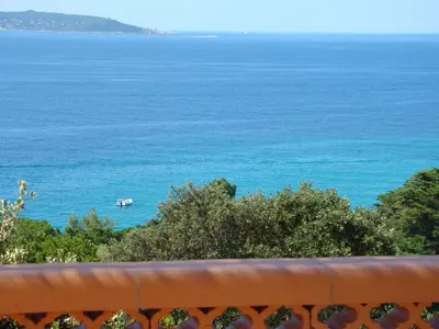 a view of the ocean with a boat in the water at VILLA 4pers, STUNNING SEA VIEW, BEACH ON FOOT 4* in Olmeto