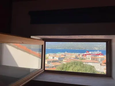 a view of a city from a window at Charmante petite maison magnifique vue mer in Propriano