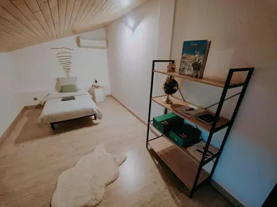a bedroom with a bed and a book shelf at Charmante petite maison magnifique vue mer in Propriano