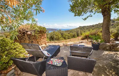 a patio with chairs and a table with a view at Cozy Home In Coti-Chiavari in Coti-Chiavari