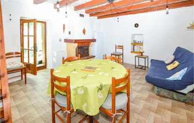 a living room with a table and a couch at Cozy Home In Coti-Chiavari in Coti-Chiavari