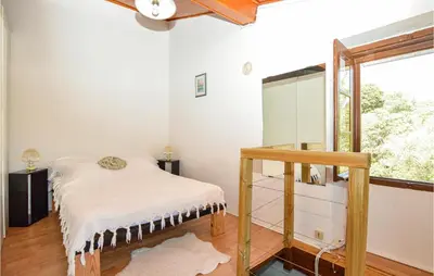 a room with a bed and a window at Cozy Home In Coti-Chiavari in Coti-Chiavari