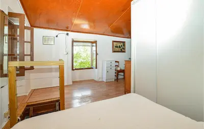 a bedroom with a bed and a wooden ceiling at Cozy Home In Coti-Chiavari in Coti-Chiavari