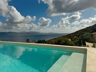 a swimming pool with a view of the water at Villa Casa Bianca Sagone Piscine privée et Vue mer Familiale in Sagone