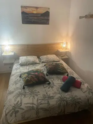 a bed with two pillows on it in a bedroom at Chambre chez l habitant 2 nuit maximum !! Une 2 eme chambre possible in Porticcio