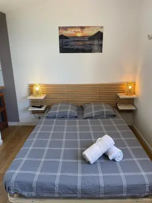 a bedroom with a bed with two towels on it at Chambre chez l habitant 2 nuit maximum !! Une 2 eme chambre possible in Porticcio