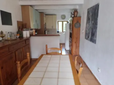 a kitchen with a table and chairs in it at Maison de caractère au coeur de la corse rurale in Calacuccia