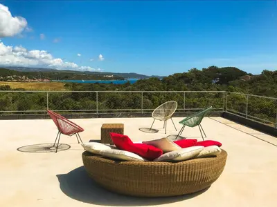a group of chairs and a couch on a patio at Villa esprit moderniste avec piscine in Bonifacio