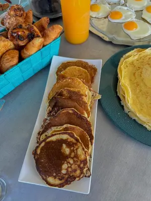 a plate of breakfast food with eggs and bread at les bungalows de Lisa Maria in SERRA DI FIUMORBO