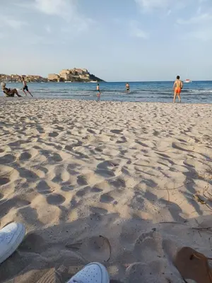 a group of people standing on a beach at maison cosy climatisée avec piscine et jardin in Calenzana