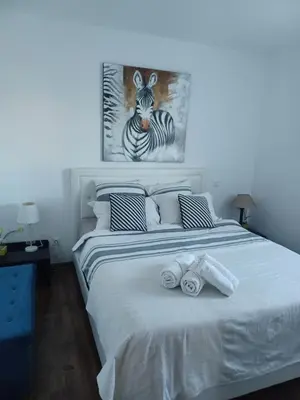 a bedroom with a bed with two rolled towels on it at maison cosy climatisée avec piscine et jardin in Calenzana
