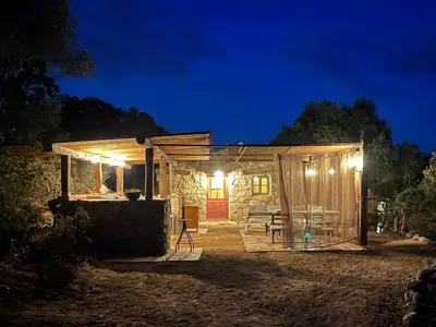 a wooden cabin with lights at night at Domaine de la Coletta Bergerie in Coti-Chiavari