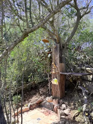 a wooden post with a rope attached to a tree at Domaine de la Coletta Bergerie in Coti-Chiavari