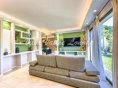 a living room with a couch and a large window at Villa Talasani in Talasani