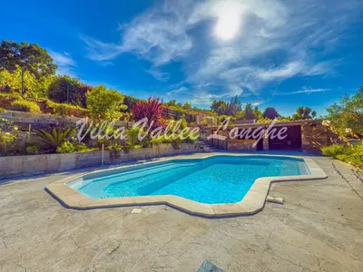 a swimming pool in the middle of a yard at Villa Talasani in Talasani