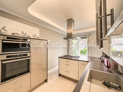 a kitchen with a stove top oven next to a sink at Villa Talasani in Talasani