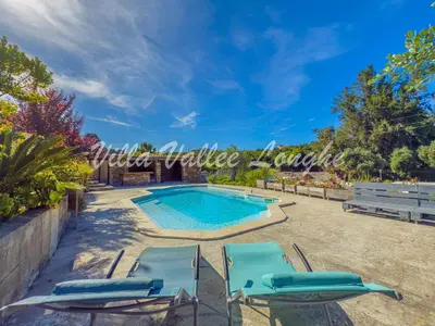 a swimming pool with blue lounge chairs and a swimming pool at Villa Talasani in Talasani