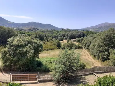 a view of a valley with mountains in the background at Charmante maisonnette situé au calme proche d'Ajaccio. in Afa