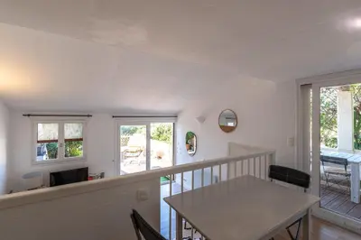 a dining room and kitchen with a table and chairs at Terra Bella - mini Villa vue mer in Grosseto-Prugna