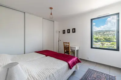 a white bedroom with a bed and a window at Vita in Grosseto-Prugna