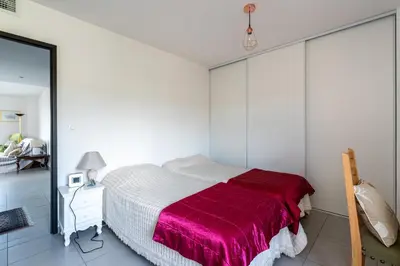 a bedroom with a bed with a red blanket at Vita in Grosseto-Prugna