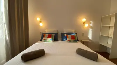 a bedroom with a large white bed with pillows at Ajaccio : Appartement de grand standing vue mer. in Ajaccio