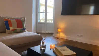 a living room with a couch and a table with a candle at Ajaccio : Appartement de grand standing vue mer. in Ajaccio