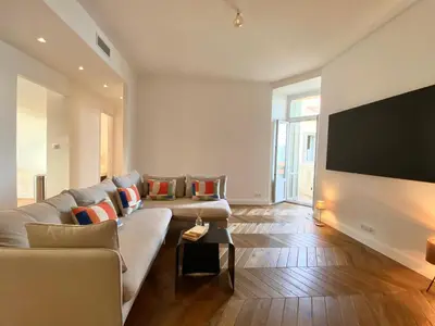 a living room with two couches and a flat screen tv at Ajaccio : Appartement de grand standing vue mer. in Ajaccio