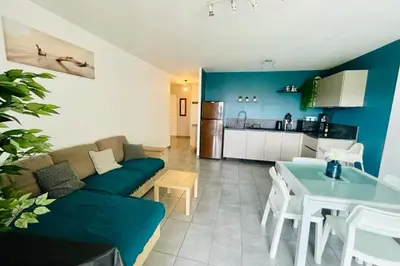 a living room with a couch and a table and a kitchen at Nice 60m With Terrace In Ajaccio in Ajaccio