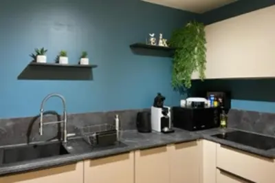 a kitchen with a sink and a blue wall at Nice 60m With Terrace In Ajaccio in Ajaccio