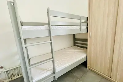 a bunk bed with a ladder in a room at Nice 60m With Terrace In Ajaccio in Ajaccio