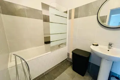 a bathroom with a sink and a bath tub and a mirror at Nice 60m With Terrace In Ajaccio in Ajaccio