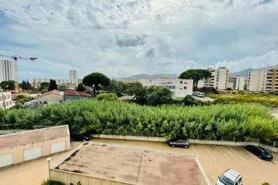 a city with cars parked in a parking lot at Nice 60m With Terrace In Ajaccio in Ajaccio