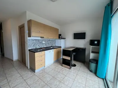 a kitchen with a sink and a counter in a room at Superbe appartement en résidence avec piscine proche plage in Linguizzetta