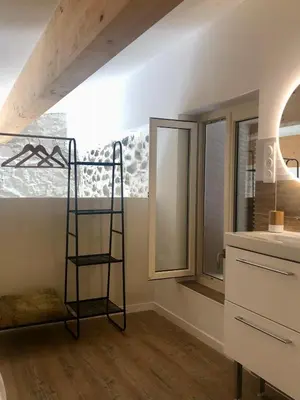 a room with a ladder next to a window at U Vechju Fragnu in Vezzani