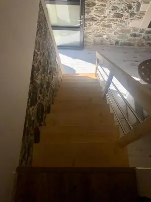 a set of stairs with a stone wall at U Vechju Fragnu in Vezzani