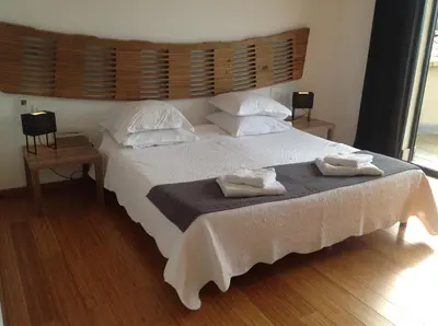 a bedroom with a large bed with towels on it at Villa St Exupery in Oletta