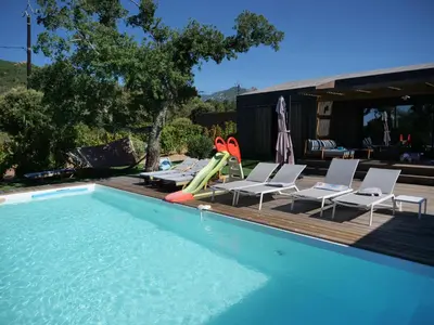 a swimming pool with chairs and a pool slide at DI SOGNI - Villa d'Archi, 8 pax, pisc Chauffée in Gialla
