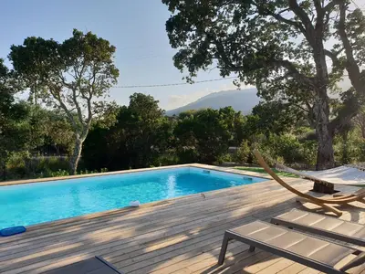 a pool with a chair and a hammock on a deck at DI SOGNI - Villa d'Archi, 8 pax, pisc Chauffée in Gialla