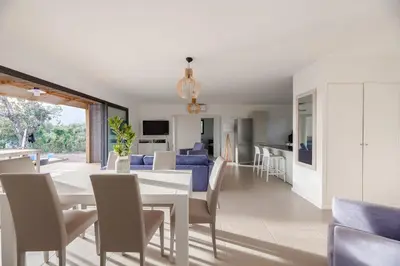 a dining room and living room with a table and chairs at DI SOGNI - Villa d'Archi, 8 pax, pisc Chauffée in Gialla